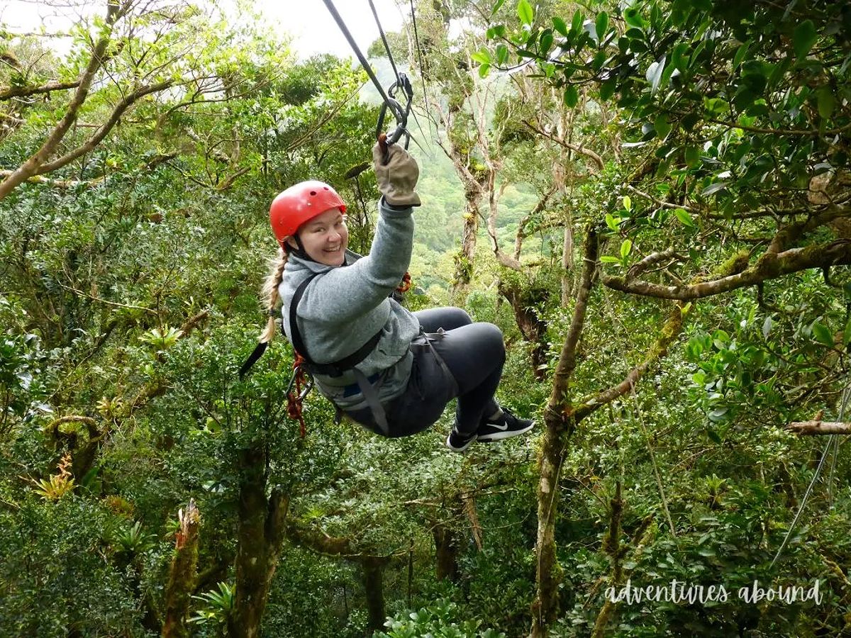 A girl ziplining through the lush canopy in Costa Rica.