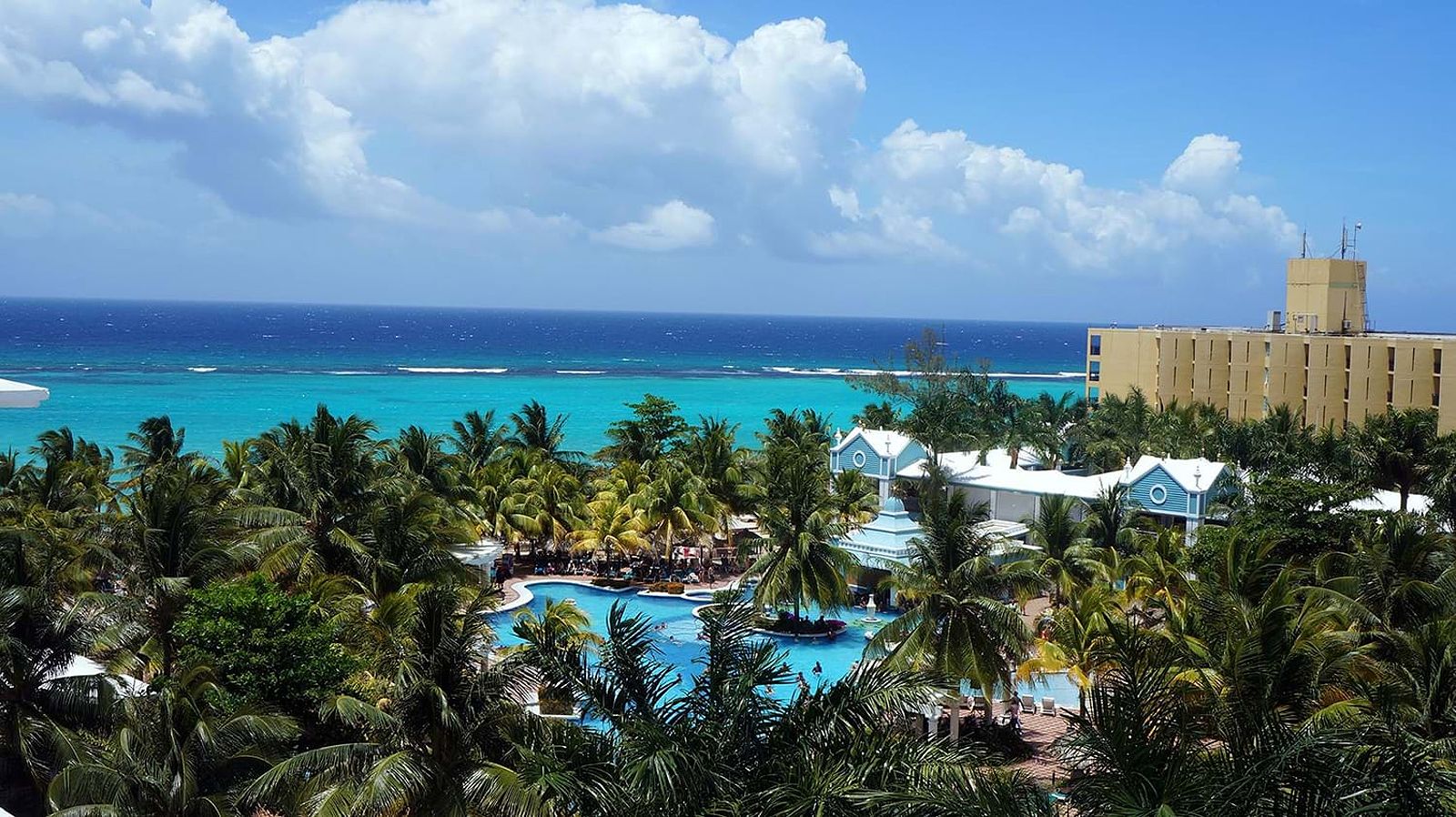 Relaxing resort pool by the ocean, perfect for family stays.